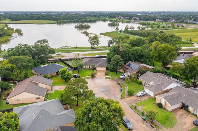 drone / aerial view featuring a water view and a residential view