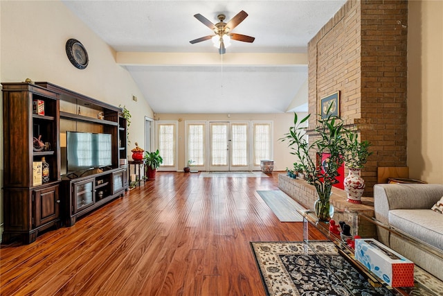 living room featuring lofted ceiling with beams, ceiling fan, wood finished floors, and french doors