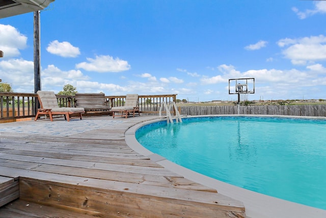 view of pool featuring a fenced in pool, fence, and a wooden deck