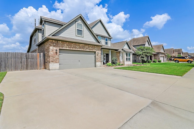 traditional-style home with driveway, a garage, fence, a front lawn, and brick siding