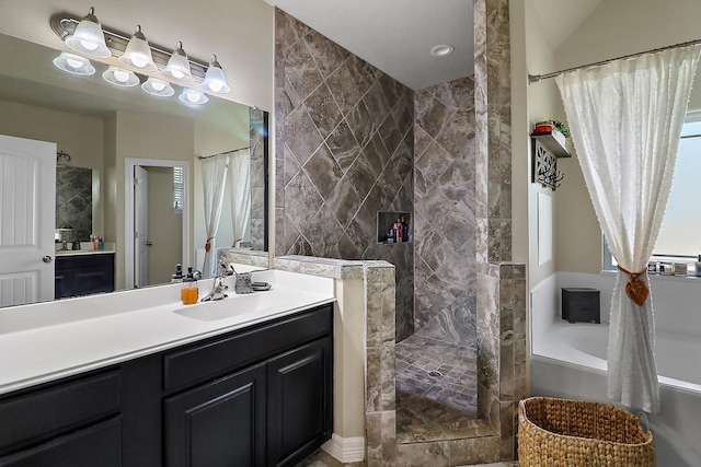 bathroom with a tile shower, a garden tub, and vanity