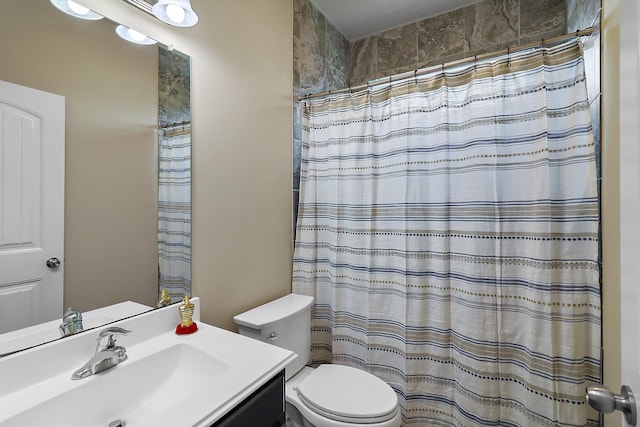 bathroom with toilet, curtained shower, and vanity