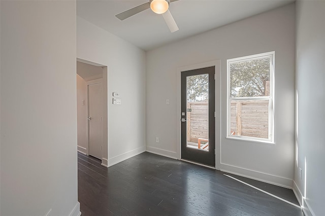 entryway featuring a ceiling fan, dark wood finished floors, and baseboards