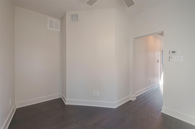 spare room featuring dark wood-type flooring, baseboards, and ceiling fan