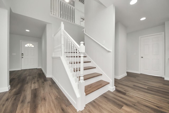 entryway featuring recessed lighting, dark wood finished floors, stairway, and baseboards