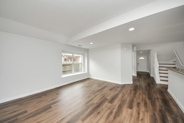 spare room featuring recessed lighting, dark wood-style flooring, stairway, and baseboards