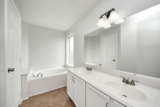 bathroom featuring a bath, tile patterned flooring, double vanity, and a sink