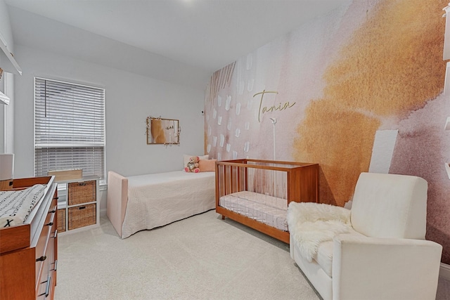 bedroom with wallpapered walls and light colored carpet