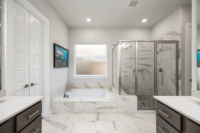 full bathroom with marble finish floor, a garden tub, visible vents, a shower stall, and vanity