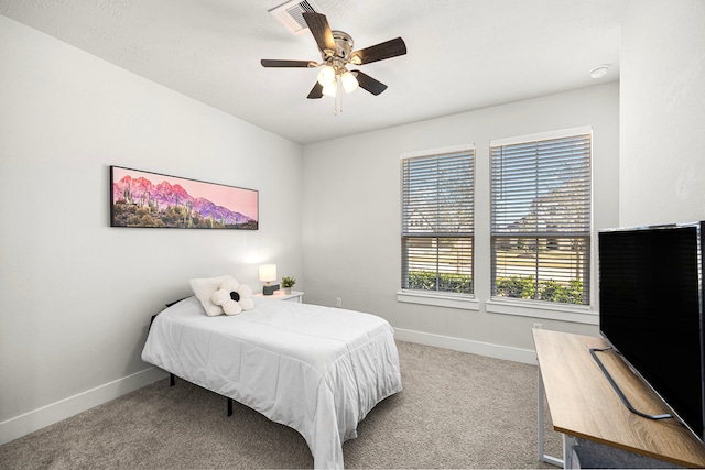 bedroom with baseboards, visible vents, a ceiling fan, and light colored carpet