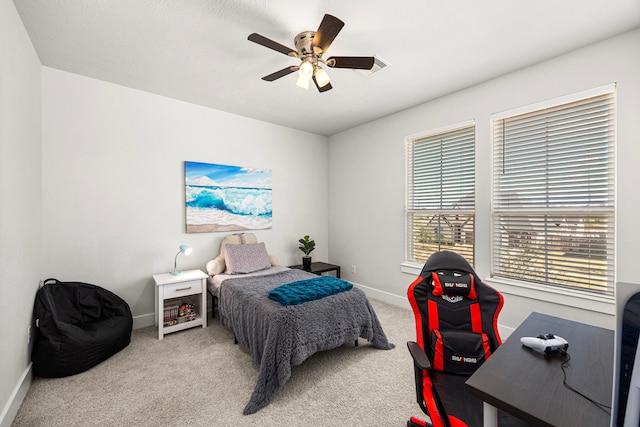 carpeted bedroom featuring ceiling fan and baseboards