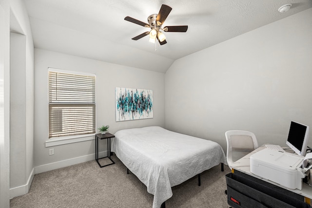 bedroom featuring light carpet, vaulted ceiling, baseboards, and ceiling fan