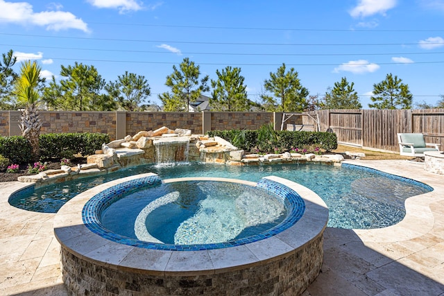 view of pool with a pool with connected hot tub, a fenced backyard, and a patio