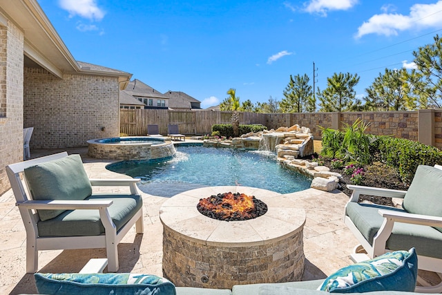 view of pool featuring a fire pit, a patio area, a fenced backyard, and a pool with connected hot tub