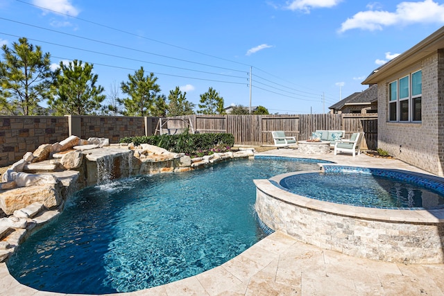 view of pool with a pool with connected hot tub, a fenced backyard, and a fire pit