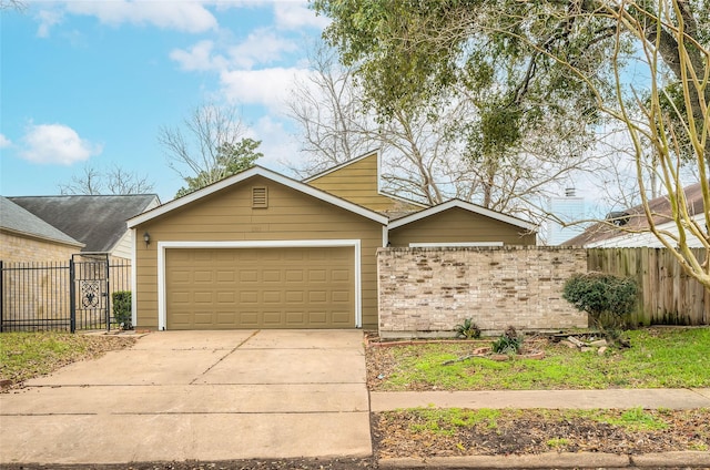 view of front of property with driveway, a garage, fence, and brick siding