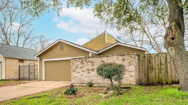 view of front of property featuring a garage, fence, concrete driveway, and brick siding