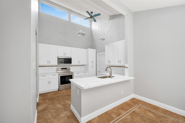 kitchen featuring tasteful backsplash, hanging light fixtures, stainless steel appliances, white cabinetry, and a sink