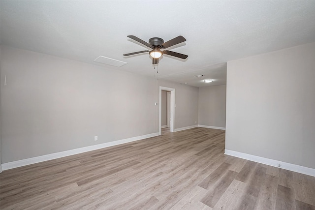 unfurnished room featuring ceiling fan, light wood-type flooring, and baseboards