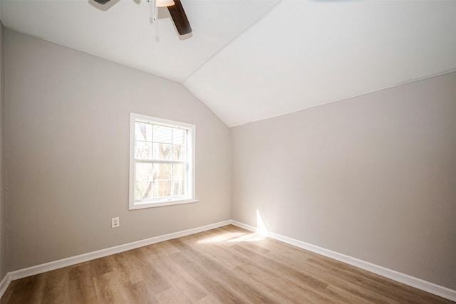 bonus room featuring a ceiling fan, light wood-type flooring, vaulted ceiling, and baseboards