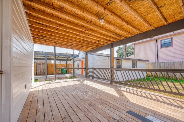 deck with a fenced backyard and a pergola