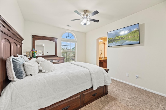 bedroom with arched walkways, carpet floors, a ceiling fan, visible vents, and baseboards