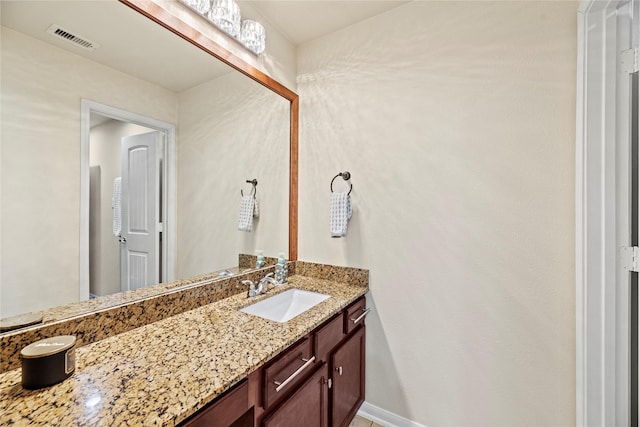 bathroom with baseboards, visible vents, and vanity