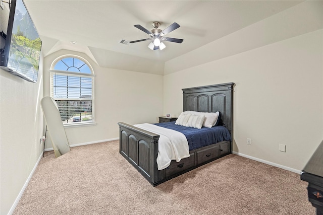 bedroom with vaulted ceiling, light carpet, visible vents, and baseboards