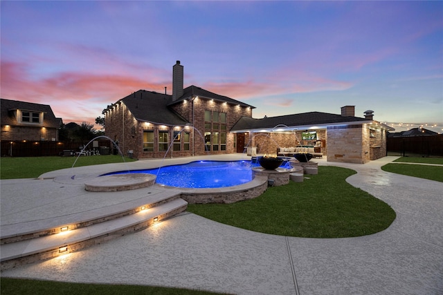 pool featuring fence, a patio, and a yard