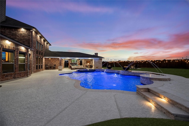 view of swimming pool featuring a pool with connected hot tub, a patio area, and fence