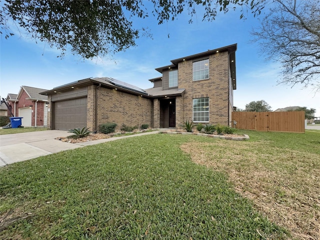 traditional-style house featuring an attached garage, brick siding, fence, concrete driveway, and a front yard