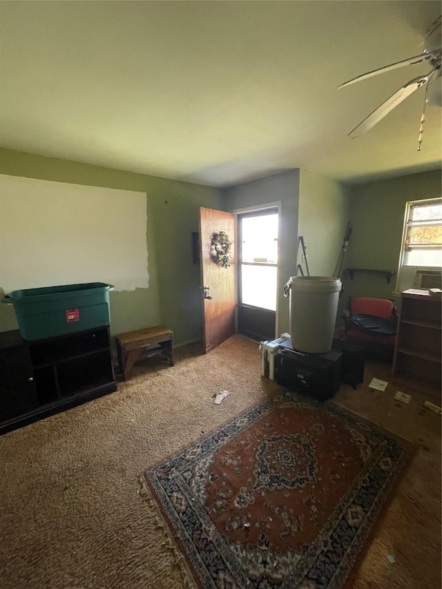 interior space with ceiling fan, carpet floors, and a healthy amount of sunlight