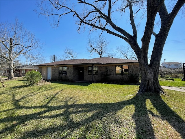 view of front of property with brick siding and a front lawn