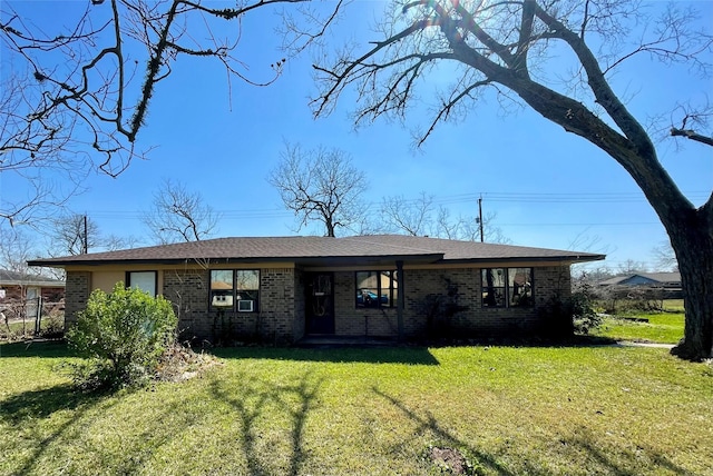 view of front of house with brick siding and a front lawn