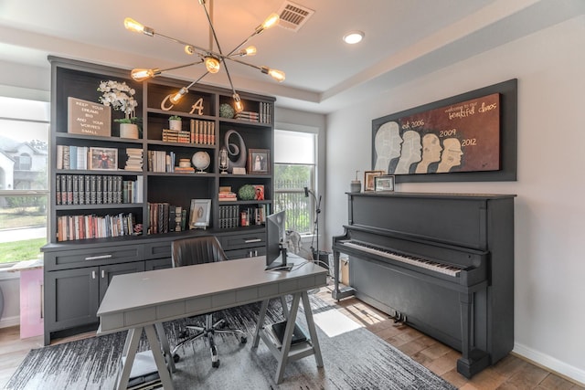 office with baseboards, visible vents, and light wood finished floors