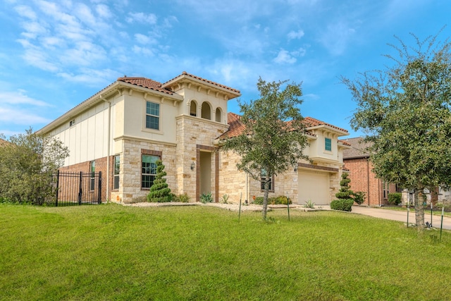 mediterranean / spanish home featuring stone siding, concrete driveway, a front yard, and fence