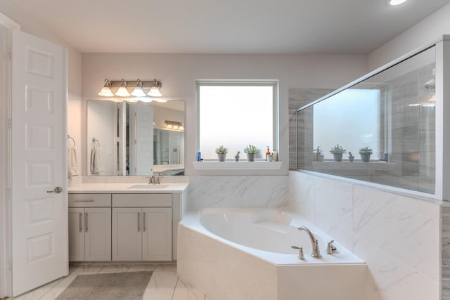 bathroom with a garden tub, marble finish floor, a shower stall, and vanity