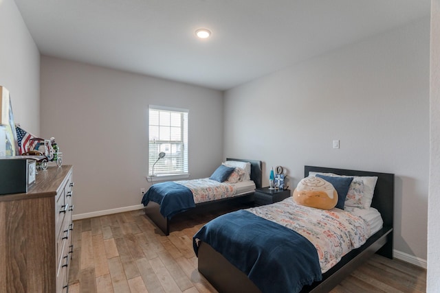 bedroom with light wood-style floors and baseboards