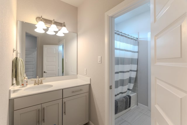 bathroom featuring shower / tub combo and vanity