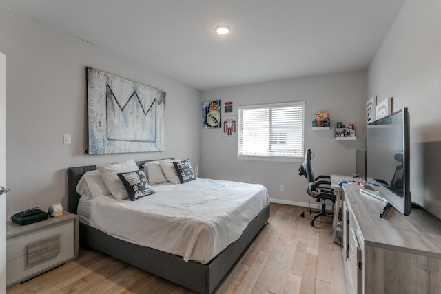 bedroom featuring light wood-style floors and baseboards