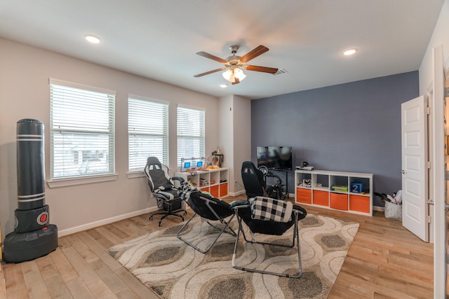 living area with light wood-style floors, recessed lighting, baseboards, and a ceiling fan