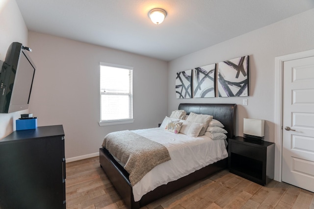 bedroom featuring baseboards and light wood-style floors