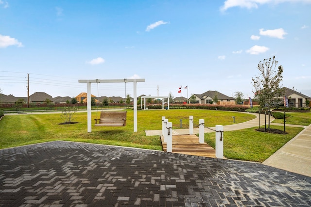 view of community featuring a residential view and a yard