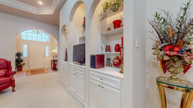 foyer with ornamental molding, recessed lighting, and light carpet