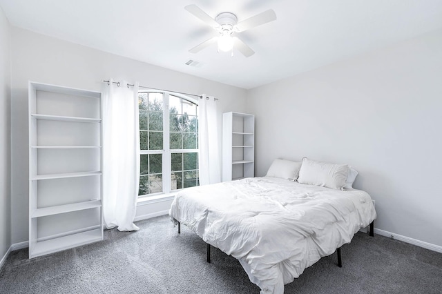 bedroom with ceiling fan, dark colored carpet, visible vents, and baseboards