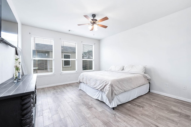 bedroom featuring light wood-style floors, baseboards, and visible vents