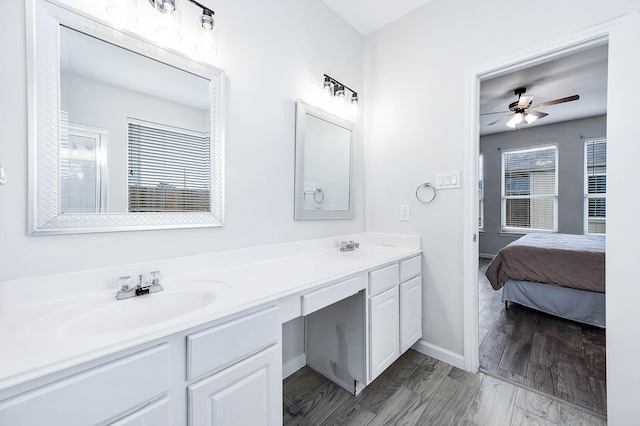 ensuite bathroom featuring a ceiling fan, double vanity, a sink, and ensuite bathroom