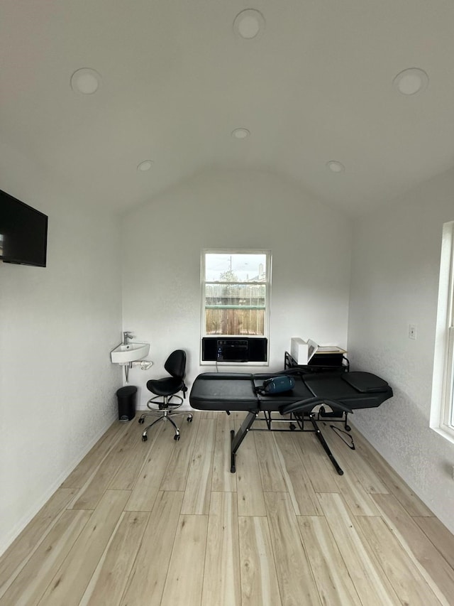 office area with lofted ceiling and light wood-style floors