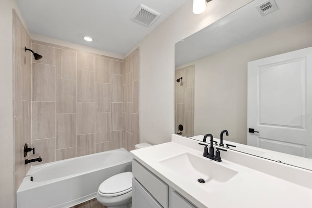 bathroom featuring shower / washtub combination, visible vents, vanity, and toilet