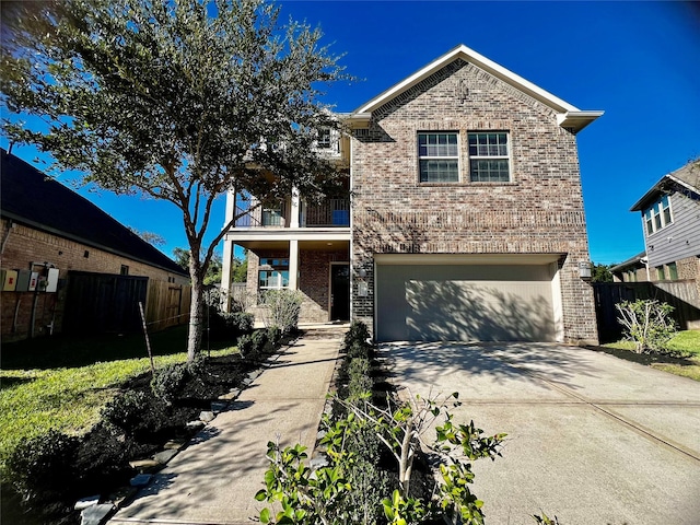 traditional-style home featuring a balcony, a garage, brick siding, fence, and driveway